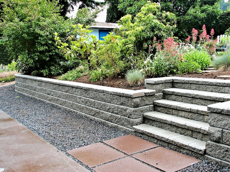 A retaining wall with built in steps into an existing garden landscape
