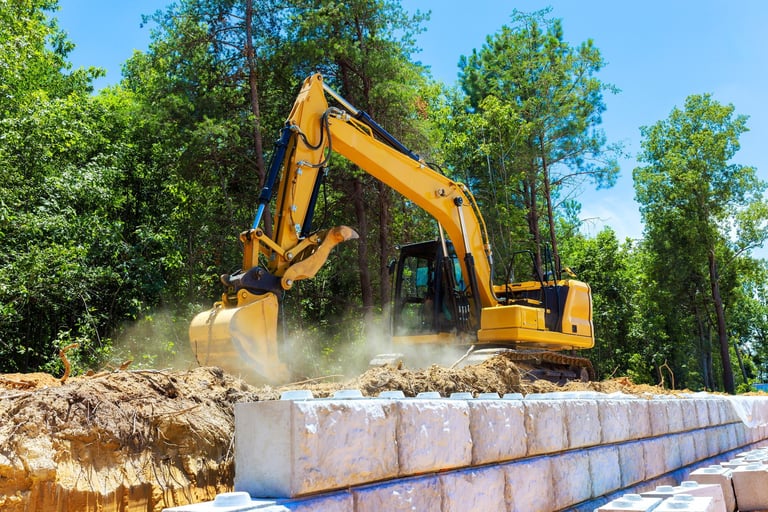 Heavy machinery digs into earth during excavation work